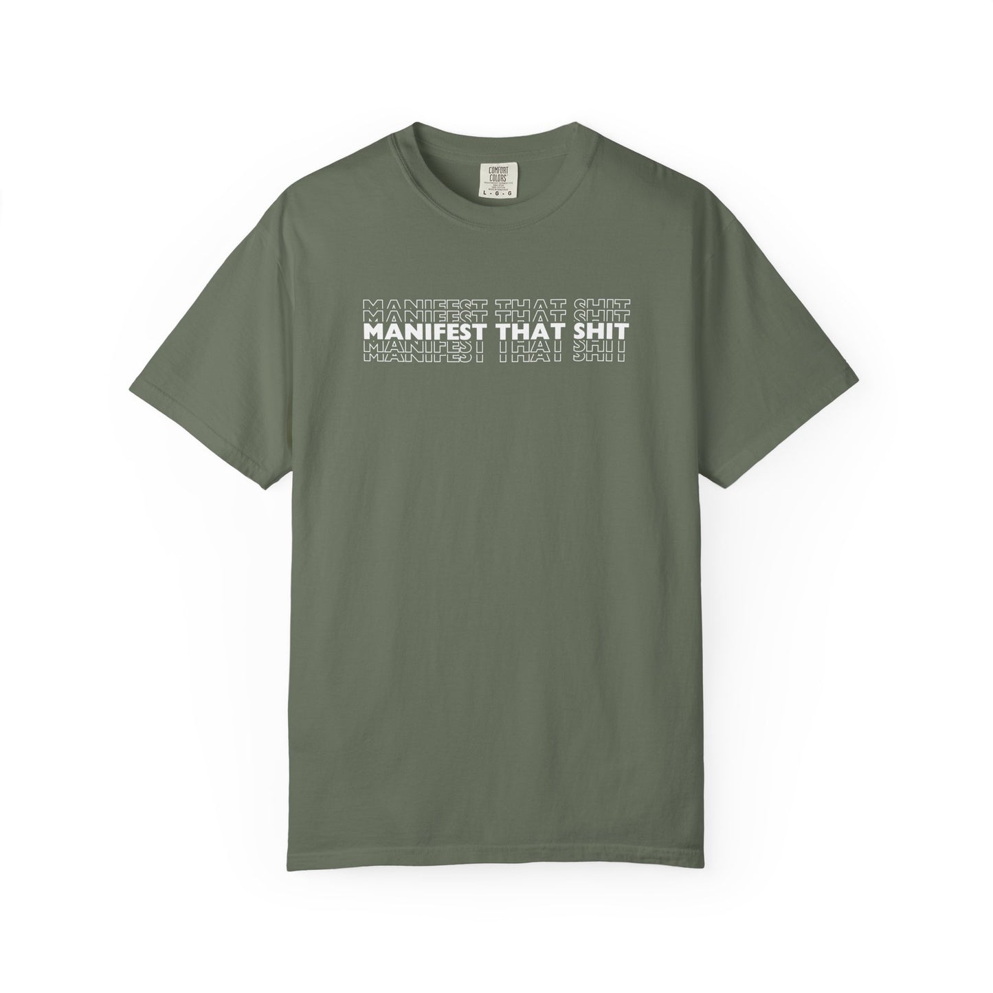 Green t-shirt with white text 'MANIFEST THAT SHIT' on a white background
