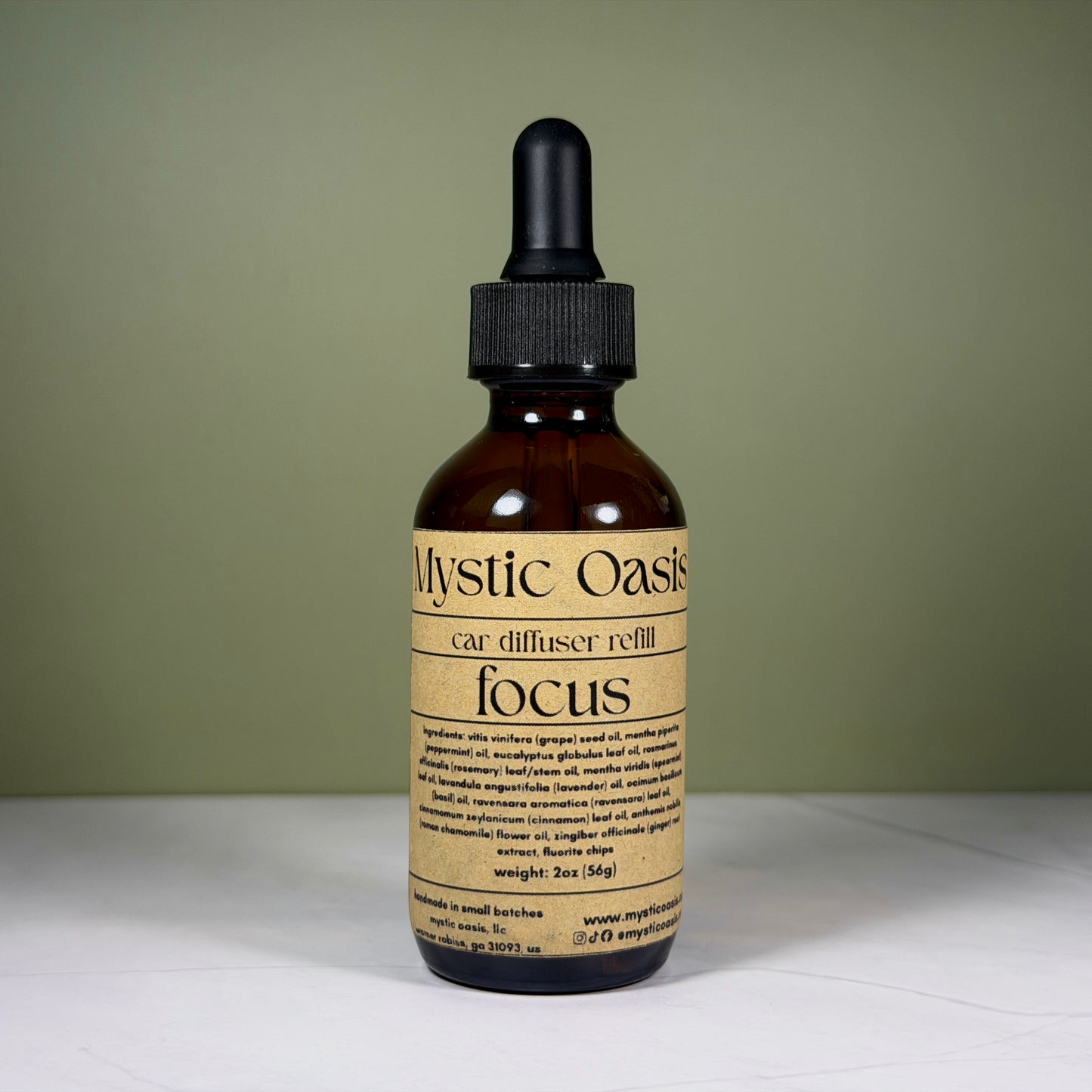 Mystic Oasis car diffuser refill bottle labeled 'focus' on a neutral background