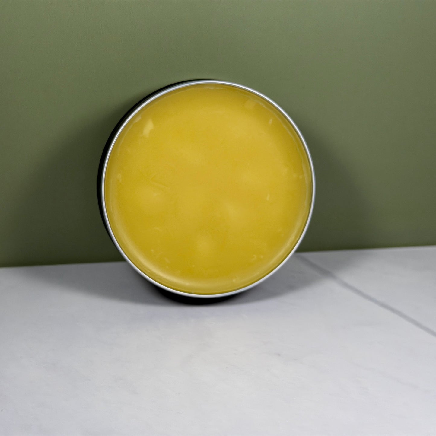 Open beard balm container showing balm 