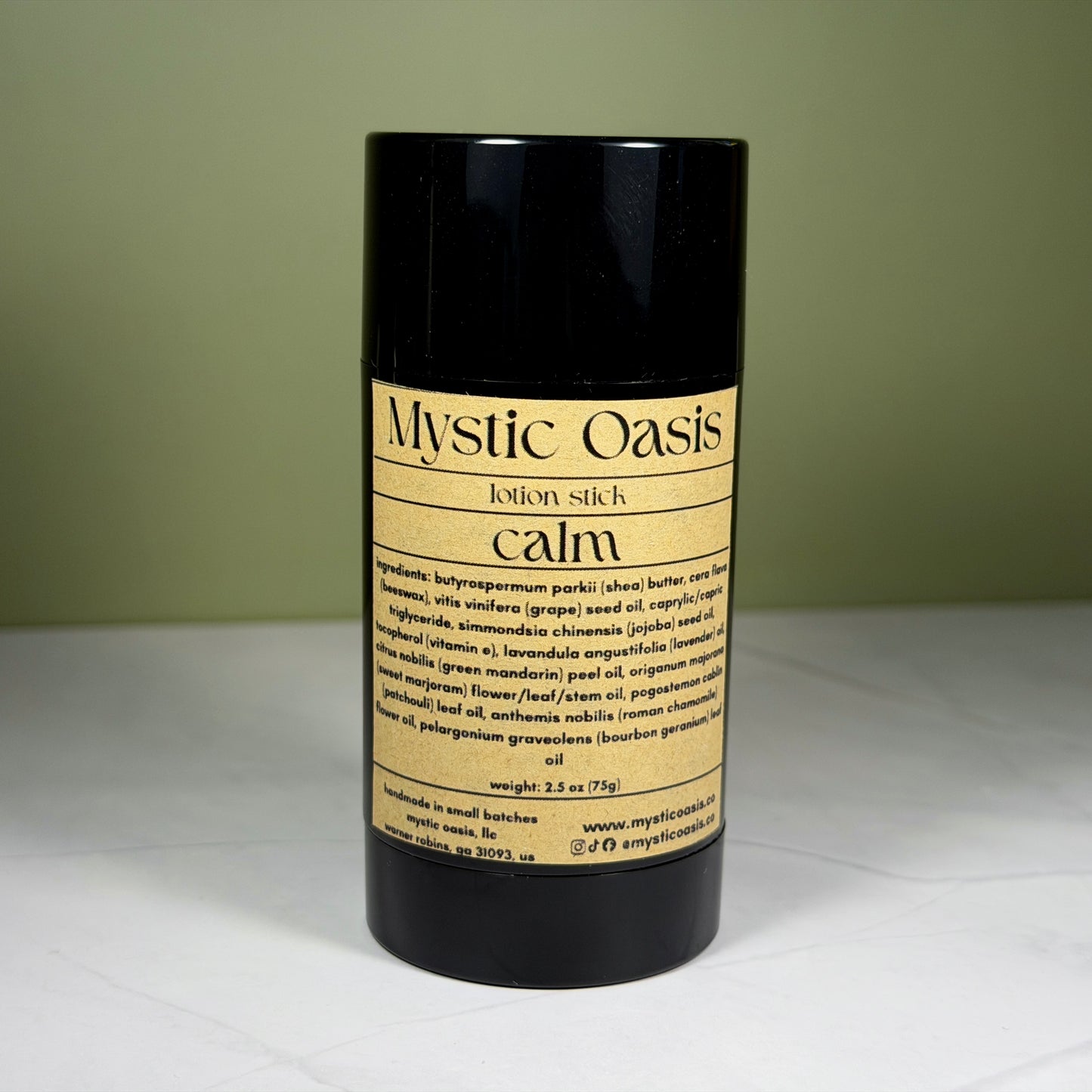 Mystic Oasis lotion stick labeled 'calm' on a white surface with a green background