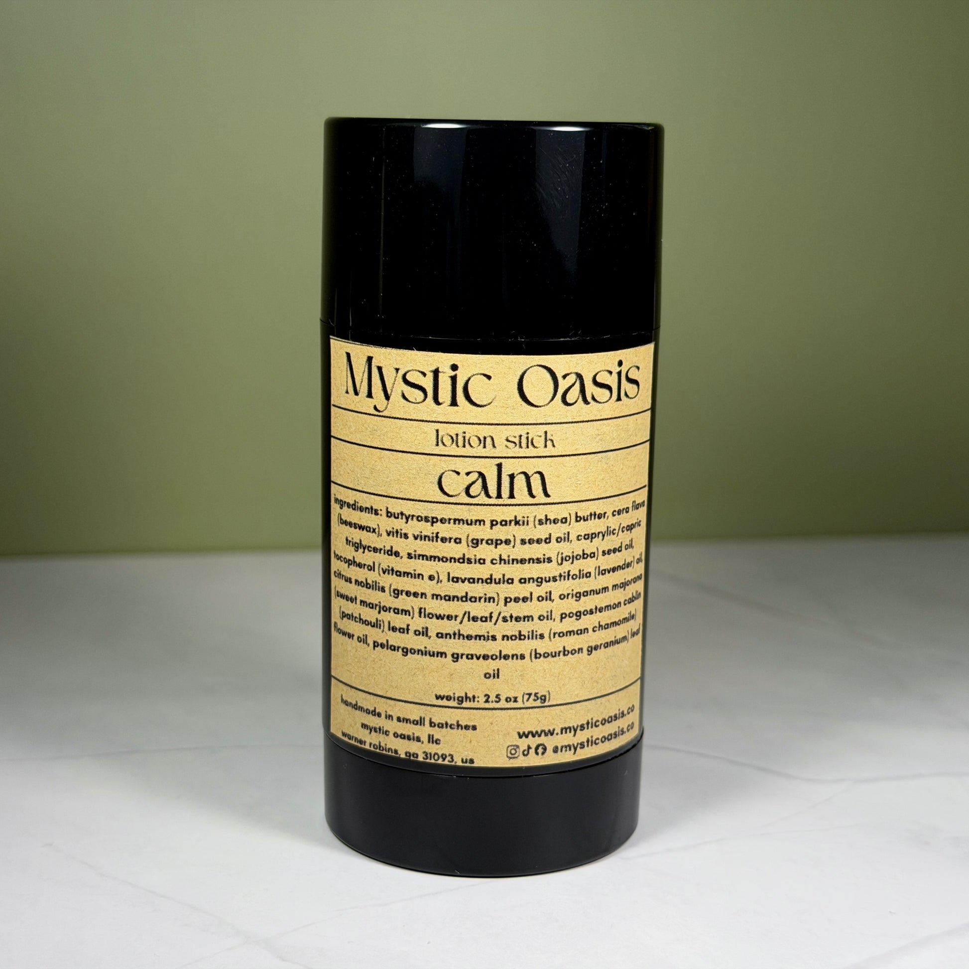 Mystic Oasis lotion stick labeled 'calm' on a white surface with a green background