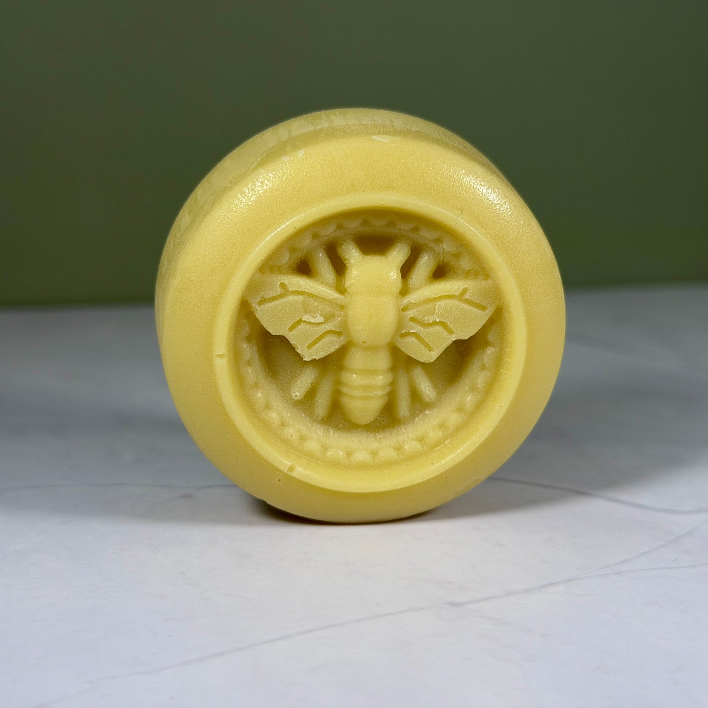Lotion bar with bee emblem 
