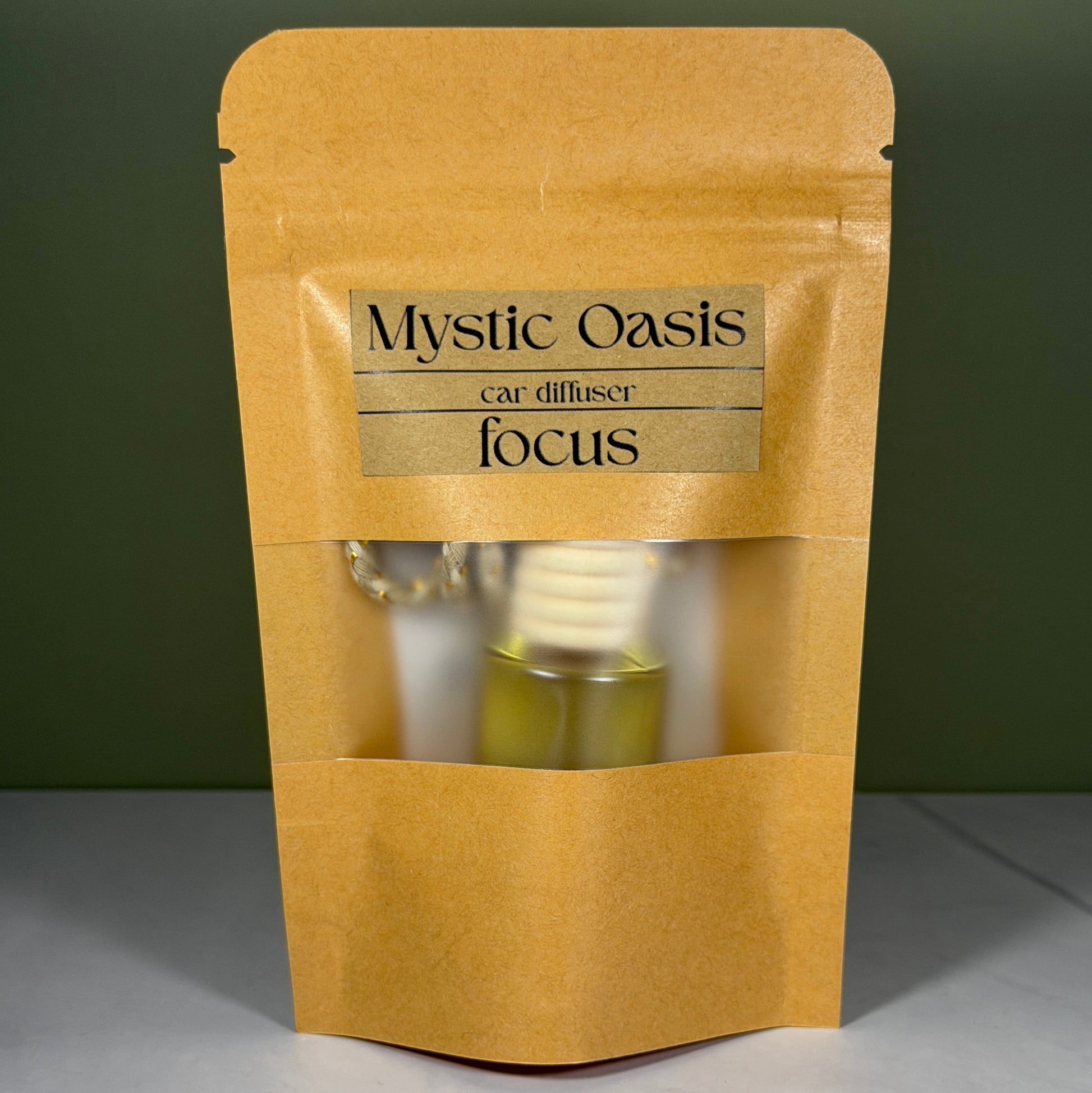 Kraft paper packaging with 'Mystic Oasis' label for a diffuser on a green background