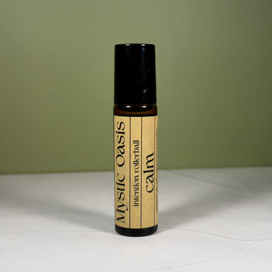Rollerball labeled 'Calm' by 'Mystic Oasis' on a white surface with a green background