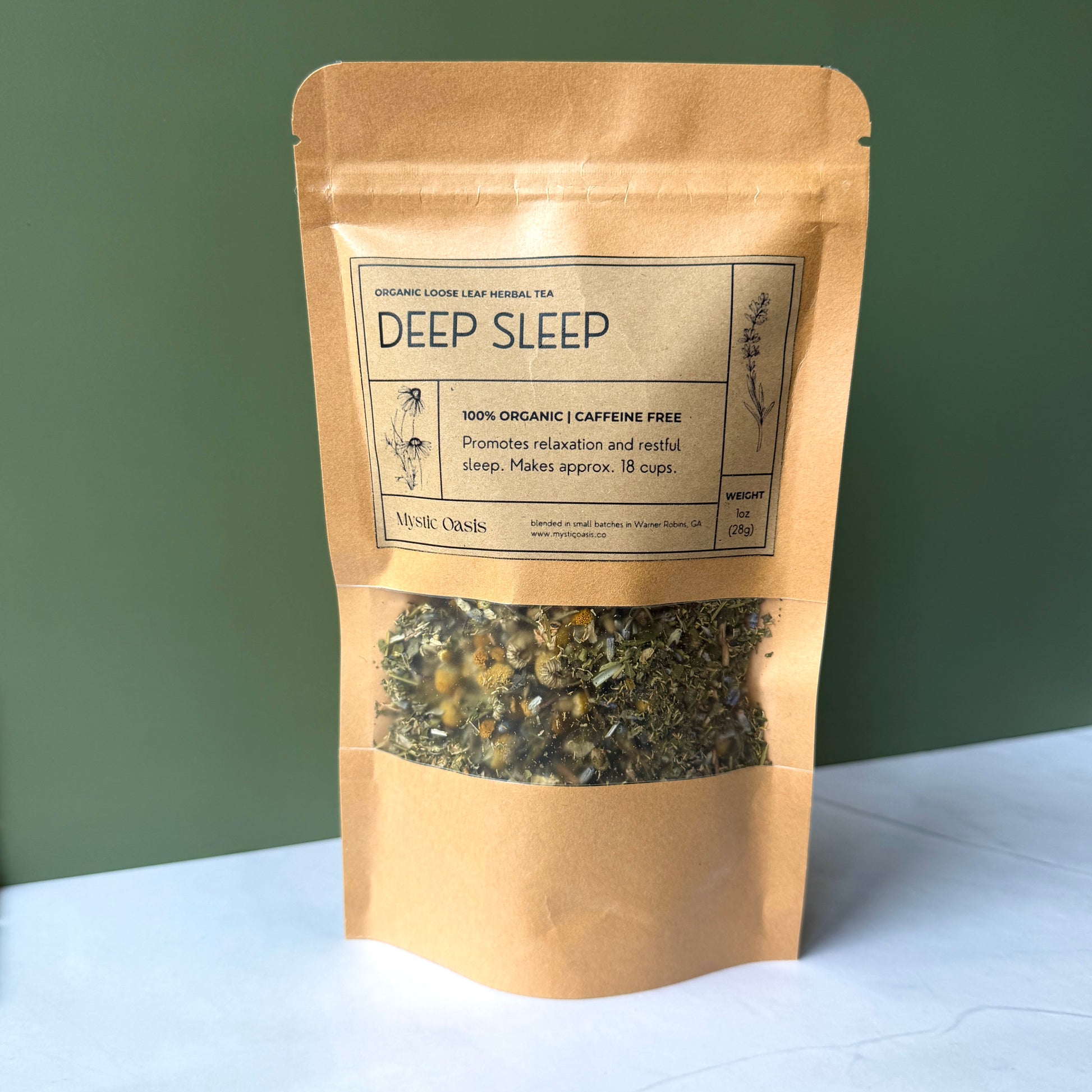 Kraft paper packaging of 'Deep Sleep' organic herbal tea on a white surface with a green background