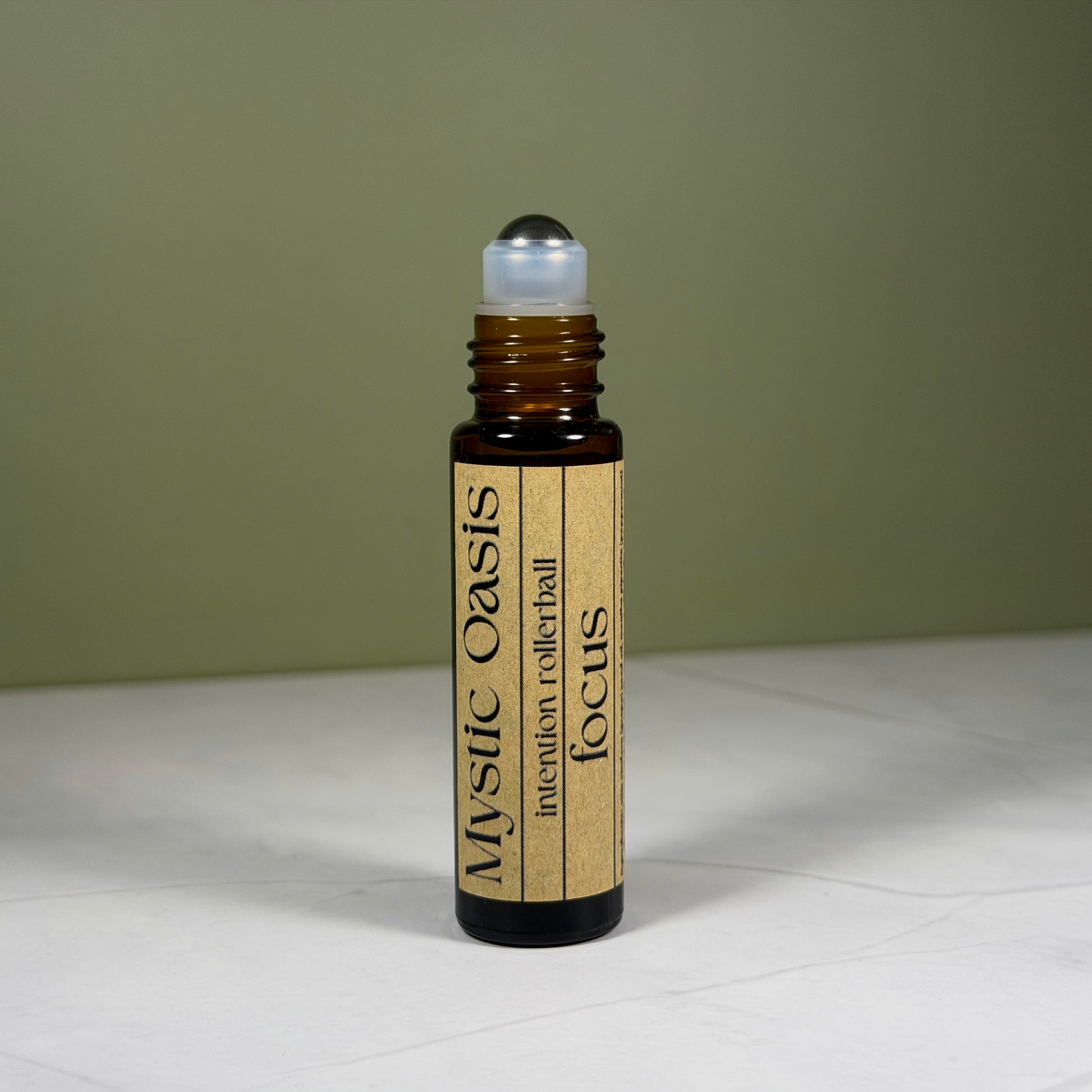 Rollerball bottle labeled 'Mystic Oasis' on a neutral background