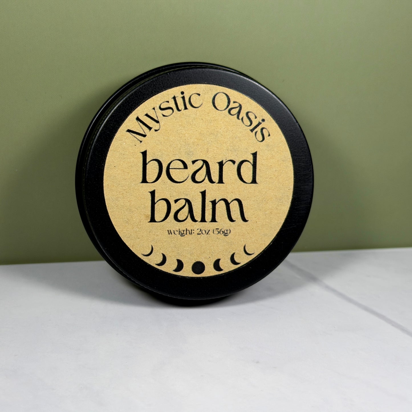 Mystic Oasis beard balm container on a white surface with a green background