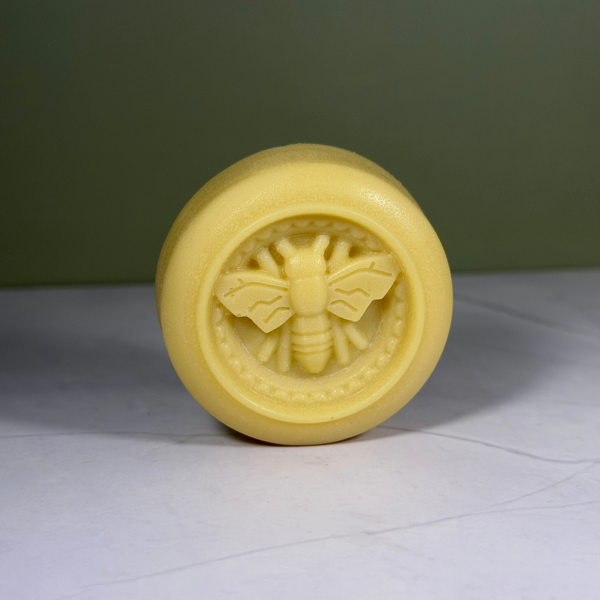 Lotion bar with bee emblem