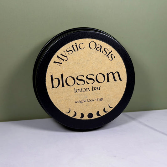 Mystic Oasis blossom lotion bar packaging on a white surface with a green background