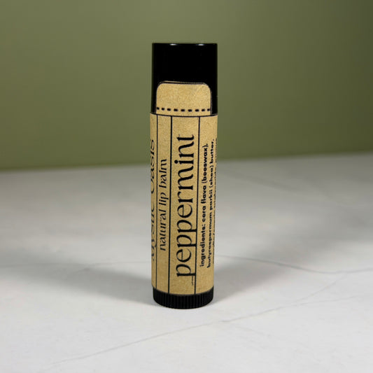 Lip balm with Kraft packaging on a light surface and green background
