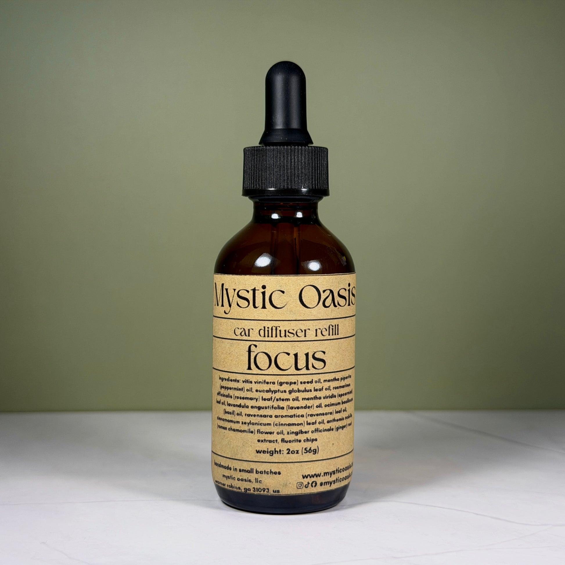Mystic Oasis car diffuser refill bottle labeled 'focus' on a neutral background