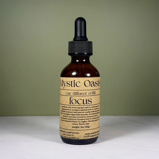 Mystic Oasis car diffuser refill bottle labeled 'focus' on a neutral background