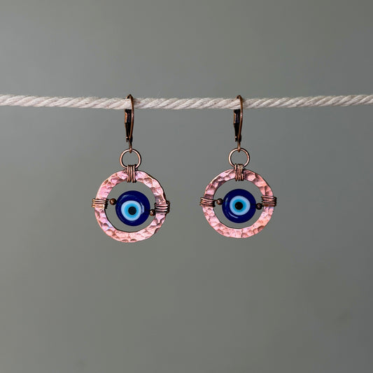 Cooper hoop earrings with glass evil eye bead in the center