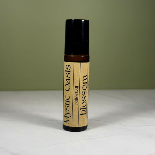 Roll-on bottle labeled 'Mystic Oasis' with 'blossom' on a neutral background